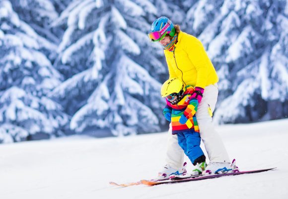 Mother and little child skiing in Alps mountains
