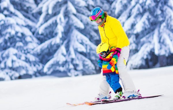 Mother and little child skiing in Alps mountains