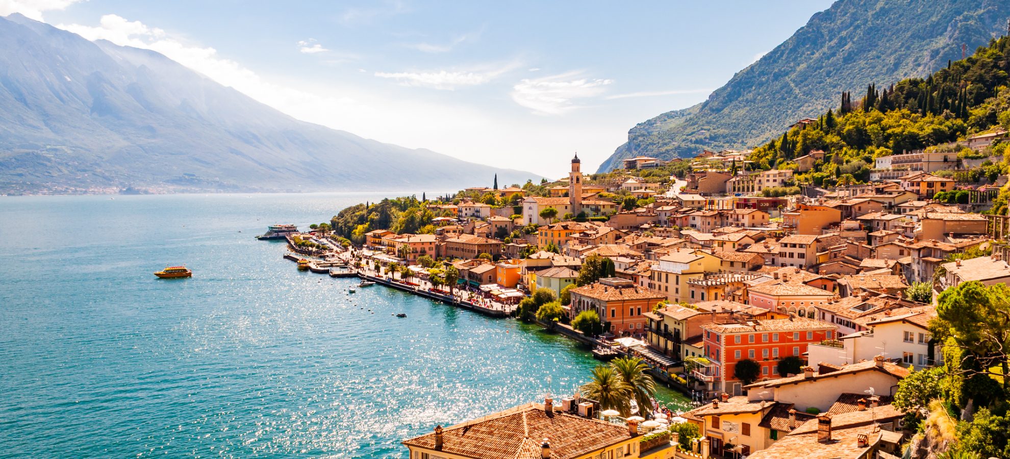 Limone Sul Garda cityscape on the shore of Garda lake surrounded by scenic Northern Italian nature