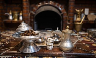 Dates and a metal teapot and cups
