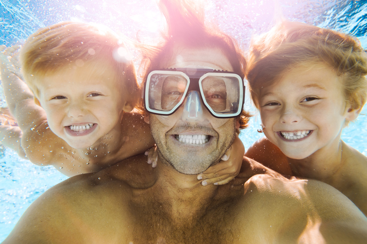 Dad and Sons Having Fun Doing A Selfie Underwater